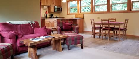 Living room, dining table, and kitchen.  