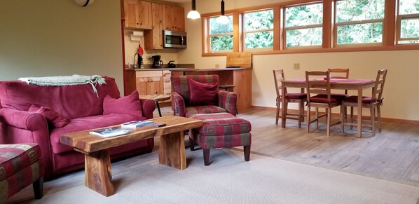 Living room, dining table, and kitchen.  