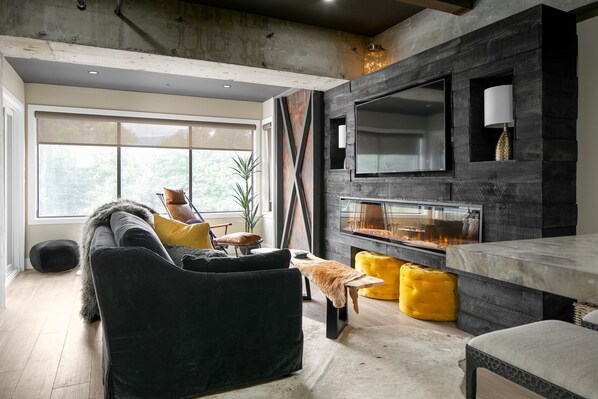 Industrial meets glam with polished concrete beams and velvet textured decor
