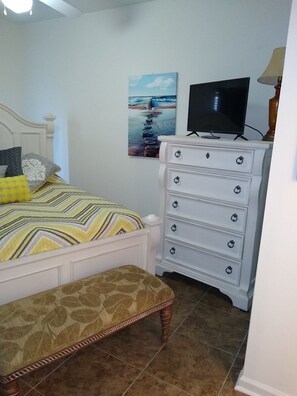 Guest Bedroom with Chest of Drawers, TV, and Mirrored Double Closet