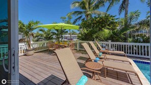 The pool deck has chaise lounges for laying out...