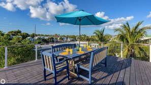 There's an outdoor dining set with an umbrella...