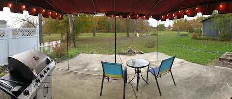 View of the backyard from the patio. Grill and fire pit available.