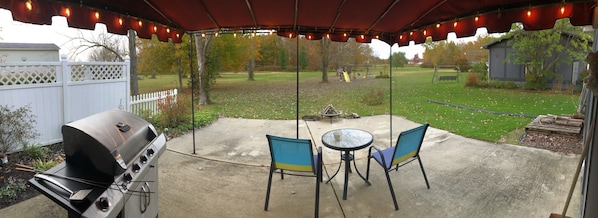 View of the backyard from the patio. Grill and fire pit available.