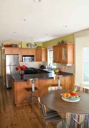 Kitchen with stainless appliances and modern and vintage furniture