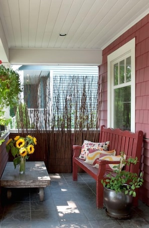 Front porch that faces beautiful tree-lined street