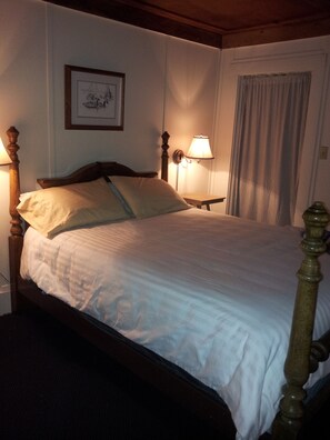 Master bedroom with attached bath featuring a clawfoot bathtub and view of river