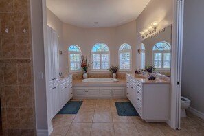 Master bath with double vanity, large soaker tub and walk in shower. 