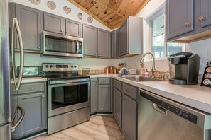 Prepare a meal in our fully stocked designer stainless steel kitchen.