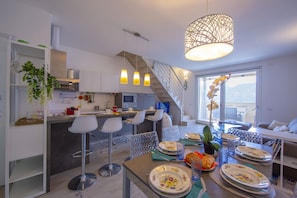 Living room dining area with view of the lake access to terrace with lake view