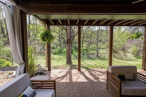 This is what you see when you walk out of the bnb. Guest's own covered patio lounge area surrounded by nature!