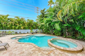 Large heated pool with tanning deck and swim up bar
