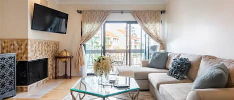 View of the living room as you enter the room with balcony.