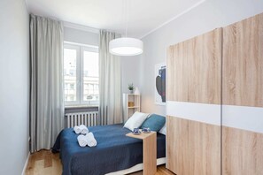 Comfortable bedroom with a double bed and wardrobe.