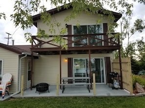 View of back patio, balcony, and shared laundry room on left