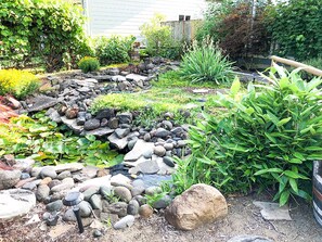 Enjoy an exotic garden and babbling stream each time you enter the house.