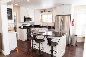 A bright and sunny kitchen with spacious island just perfect for cooking. Plenty of room to cook for a family or just to sit and chat.  The kitchen is stocked with just about every thing you could possibly need!