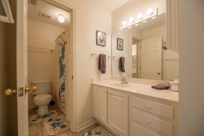 Full bathroom with tub/shower attached to master bedroom. Full + half bathroom