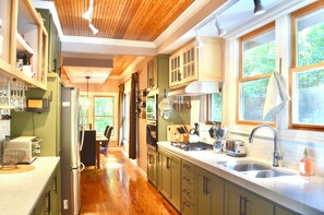 Beautiful updated galley style kitchen/dining rooms. Well stocked/easy use