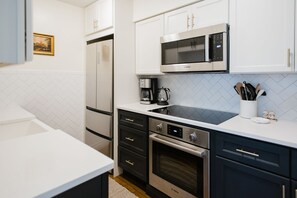 High-end stainless steel appliances, with a glass cooktop.