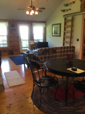 Dining room looking into living room. Table has leaf to add and seat more people