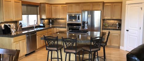 Kitchen has all new, high-end appliances, a huge island, tons of cooking tools.