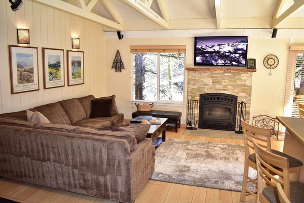 Living room with large flat screen TV and fireplace