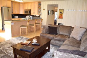 Living room view 2 with open concept kitchen