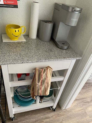 Butcher block with dishes and cooking supplies.