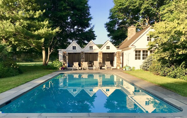 View of the pool and cottage from the grape arbor