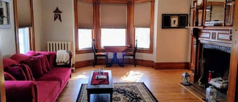 Spacious living room, with nook, and original 1880's fireplace.