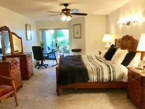 Long view of the ultra spacious master bedroom with hand-crafted oak furniture