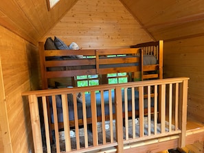 Twin bunk beds in the loft, accessible by ladder.