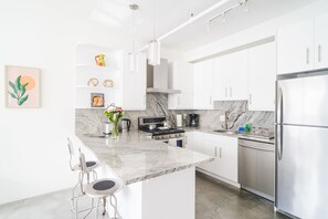 Chef's kitchen with a toaster, electric kettle, coffee maker, and dishwasher