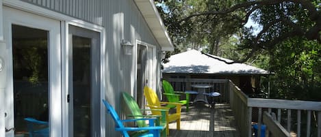 Shaded Deck with Adirondack Chairs and a outdoor dinning table.