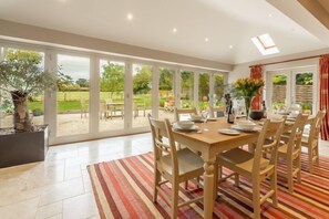 The Little House, Brancaster: Dining area with garden views