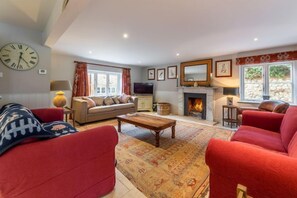 The Little House, Brancaster: Sitting room with open fire
