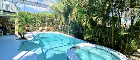 Florida luxury living! Pool boasts a sun bench...relax while sitting in the pool