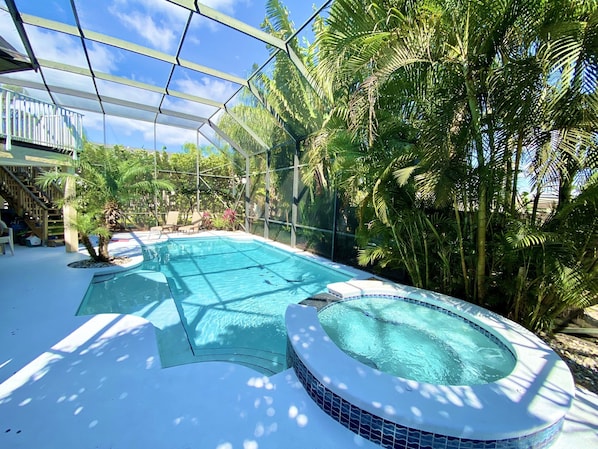 Florida luxury living! Pool boasts a sun bench...relax while sitting in the pool