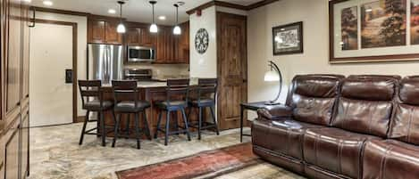 Living room and custom peninsula with room to seat 4 in the kitchen.