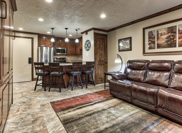 Living room and custom peninsula with room to seat 4 in the kitchen.