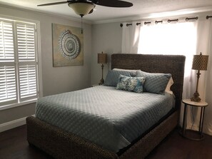 Comfortable, queen-sized bed in this sunlit bedroom.