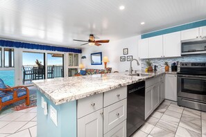 Kitchen Equipped with Dishwasher and Ocean Views while doing dishes