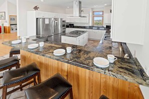 The deluxe well-equipped kitchen features 2 refrigerators, 2 dishwashers, dual wall ovens, and plenty of space for whipping up feasts.