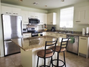 Enjoy granite countertops and stainless steel appliances with a huge island