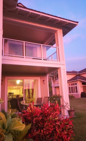 Sunset casts a pink glow on our villa, highlighting the
tropical landscaping .