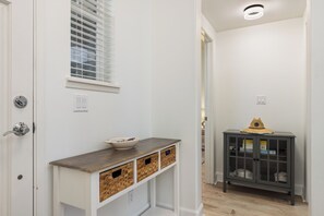 Hallway with bedroom to the left and bathroom to right