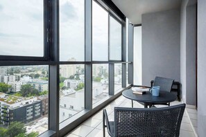 Spacious balcony with outdoor furniture. 