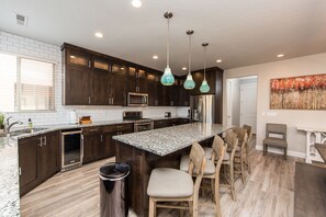 Spacious Kitchen with Double Ovens, Upgraded Appliances, and Wine Cooler. 