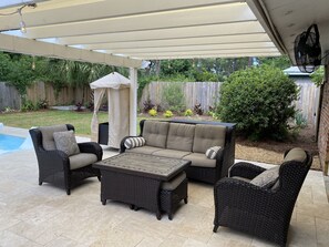 Shaded pergola seating with a towel valet.